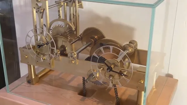 Chris’s finished brass Tower Clock, with its two open dials and wheel train inside the glass case